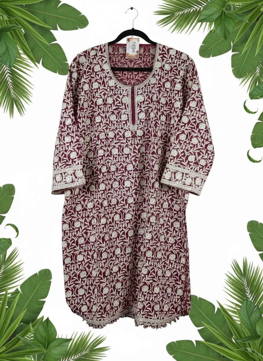 Red and white patterned shirt on a white surface