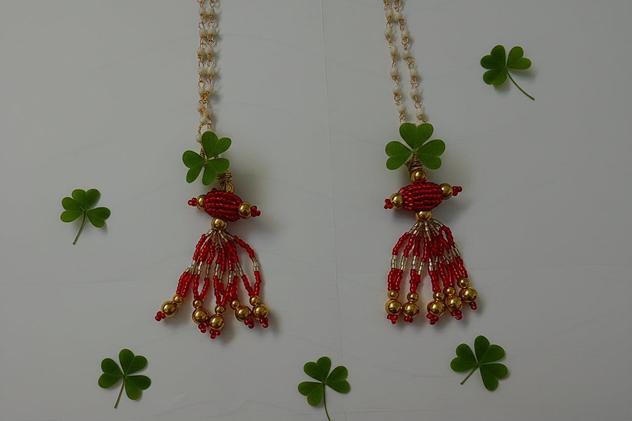 Beaded necklace with red and gold beads on a white background