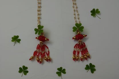 Beaded necklace with red and gold beads on a white background