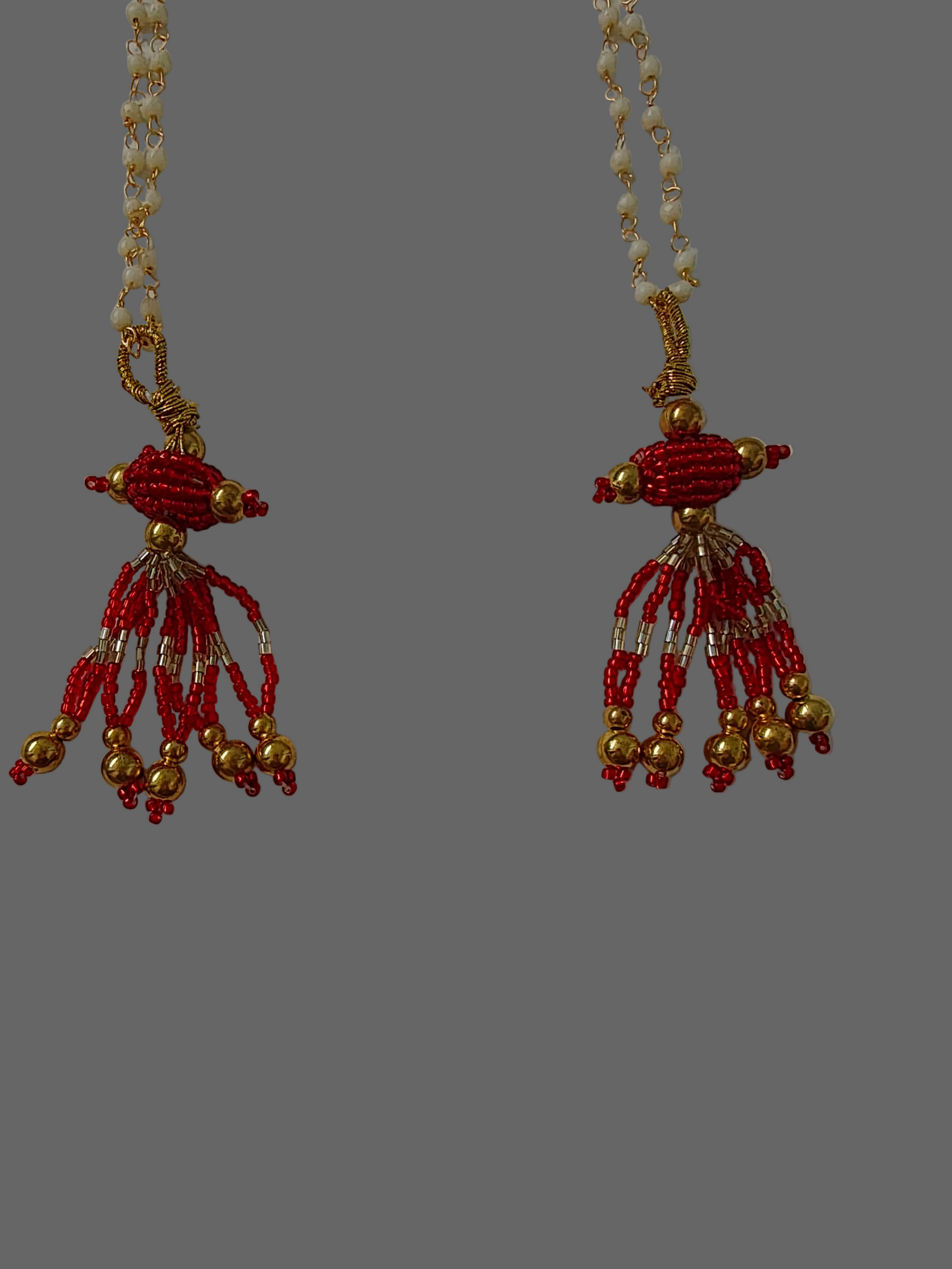 Beaded necklace with red and gold beads on a white background