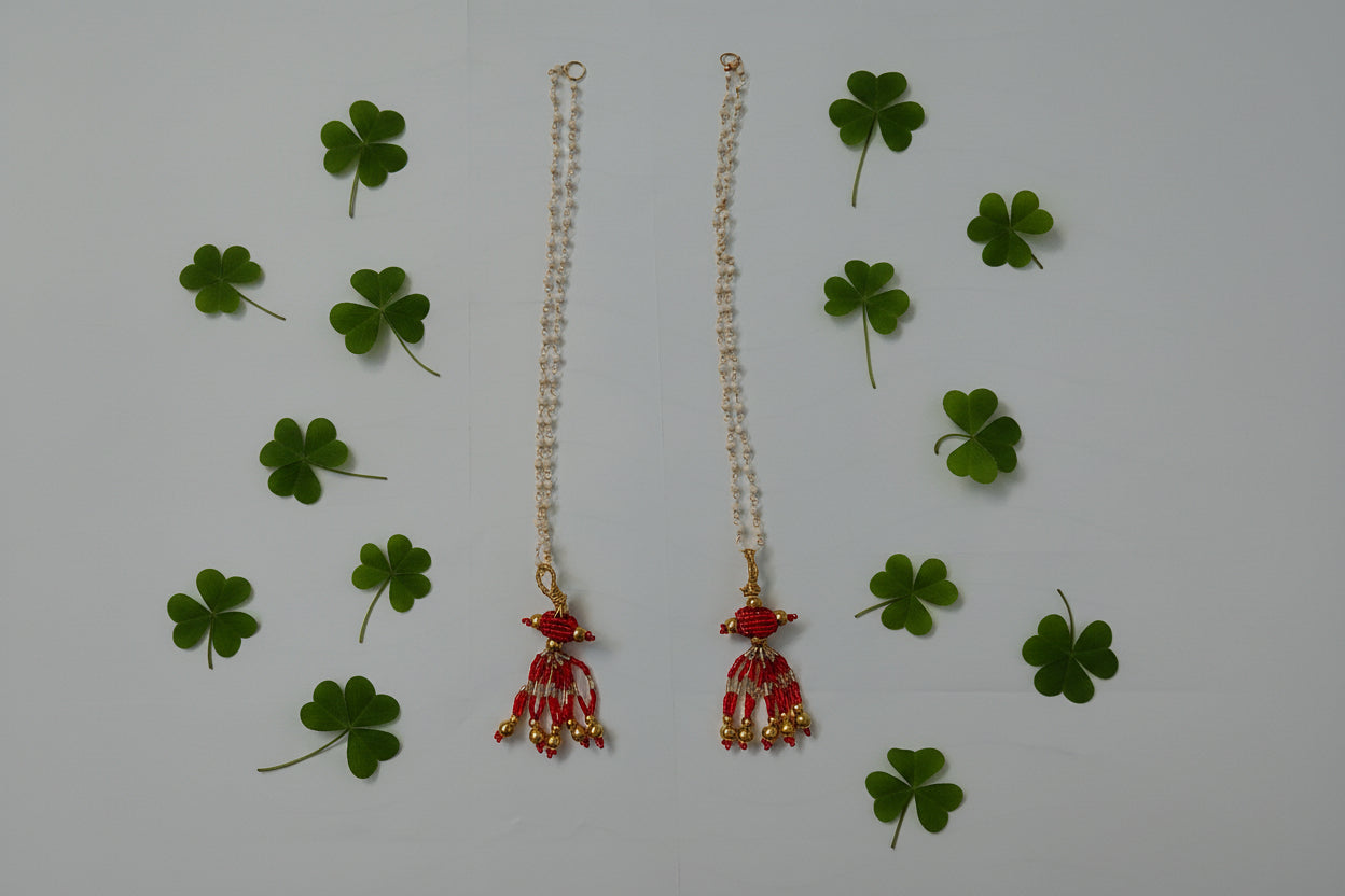 Decorative hair accessory with red and gold elements on a gray background