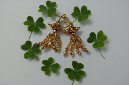 Gold decorative piece on a light gray background