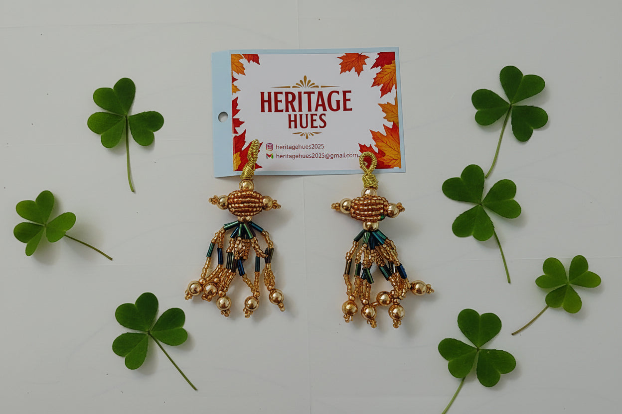 Gold earrings with intricate designs on a white background, next to a 'Heritage Hues' card.