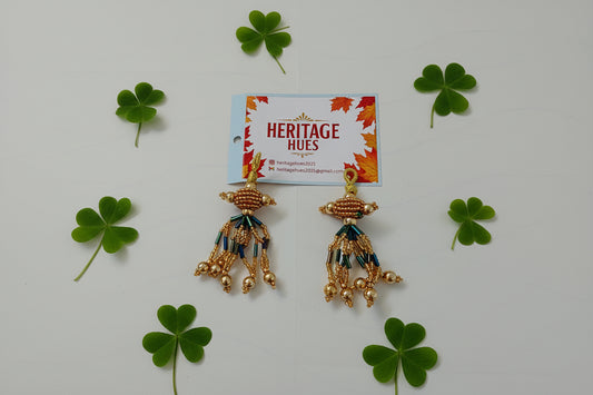 Gold earrings with blue accents on a white background, next to a 'Heritage Hues' card.