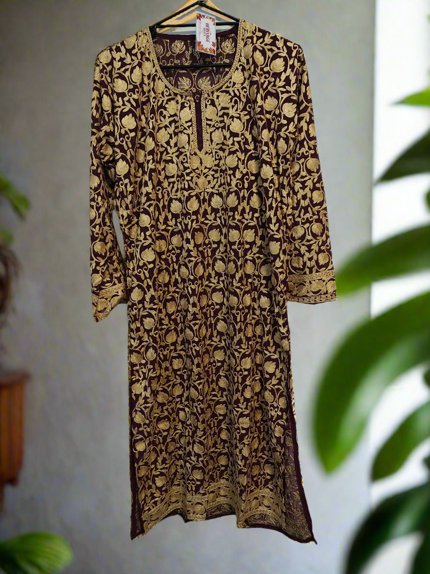 Long-sleeve dress with a pattern on a hanger against a light background