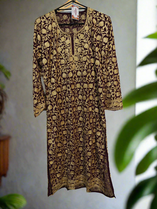 Long-sleeve dress with a pattern on a hanger against a light background