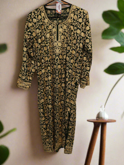 Leopard print onesie on a hanger against a white wall